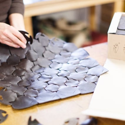 Recycled leather pieces being sewn into a bag at sustainable luxury fashion brand Elvis and Kresse.