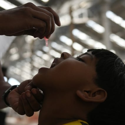 An Indian health official administers polio vaccine drops at a railway station in Chennai. Photo: AFP
