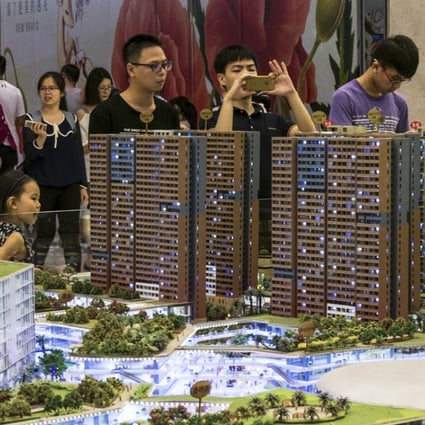 Chinese property investors viewing scale models of apartments in Shenzhen, Guangdong province. China’s housing ministry on Tuesday ordered six provinces, including Guangdong, to rethink their pre-sale system. Photo: Alamy