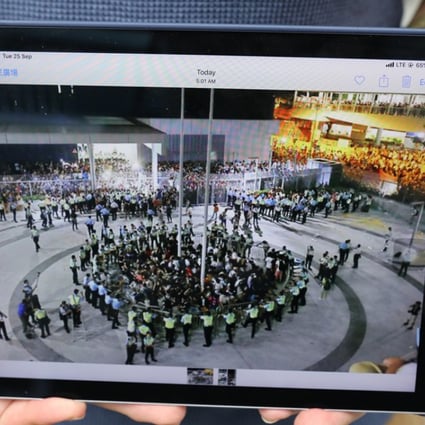Demosisto chairman Ivan Lam Long-yin poses with a photo of a pre-Occupy protest at so-called Civic Square. Photo: K.Y. Cheng