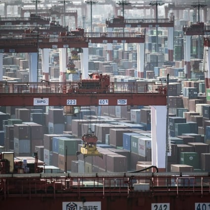 Containers stacked next to gantry cranes at the Yangshan Deep Water Port in Shanghai on Tuesday, July 10, 2018. Photo: Qilai Shen/Bloomberg