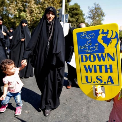 An Iranian girl raises an anti-US sign as she marches with others during a demonstration following weekly Muslim Friday prayers in the capital Tehran. Photo: AFP