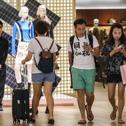 Shoppers exit Louis Vuitton at Times Square in Causeway Bay, Hong Kong. Many consumers choose to make their purchases while travelling overseas. Photo: Dickson Lee