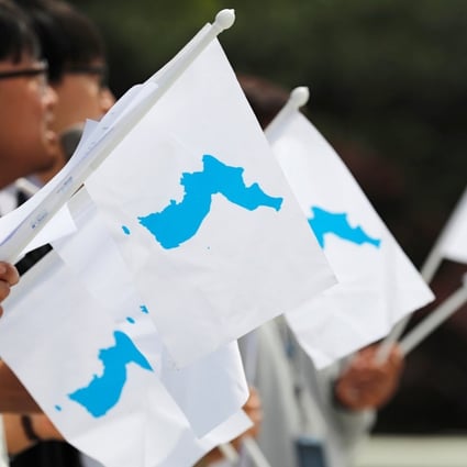 Students hold Korean unification flags ahead of the first of three summits so far this year between North and South, in Seoul in April. Photo: Reuters