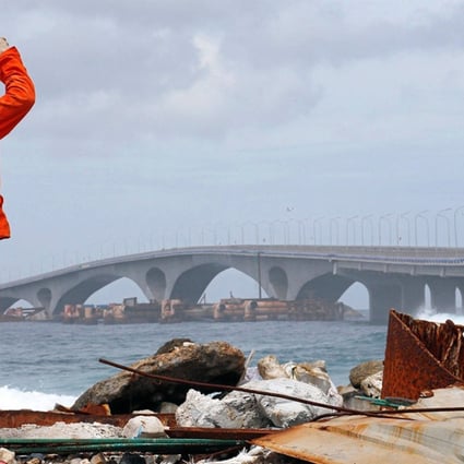 A construction worker looks towards the China-funded Sinamale bridge in Male, Maldives. Photo: Reuters