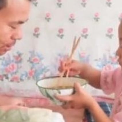 Jiajia gives her father, Tian Haicheng, breakfast before she goes to school. Photo: Handout