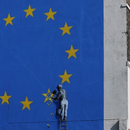 In a mural on the side of a building in Dover, Britain, street artist Banksy depicts Brexit as a workman chipping away a star on a European Union flag. The Europeans are not letting Britain make an easy exit; it might encourage the beginning of the end of European federalism. Photo: Bloomberg