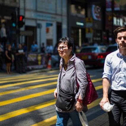 Hong Kong’s high salaries come at a price, with 50 per cent of expatriates saying they work longer hours here. Photo: AFP