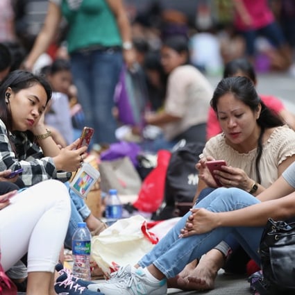 Domestic workers gather in Central on a public holiday. Photo: Edward Wong