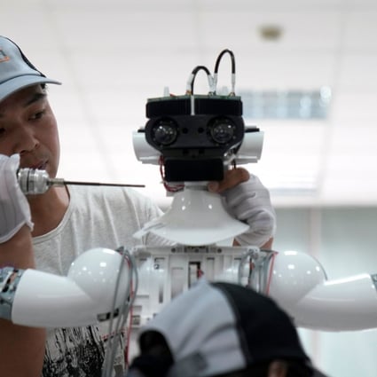 A worker puts the finishing touches to an iPal social robot, designed by AvatarMind, at an assembly plant in Suzhou, Jiangsu province, China, on July 4. Robotics is one of the focus areas under the Made in China 2025 plan. Photo: Reuters