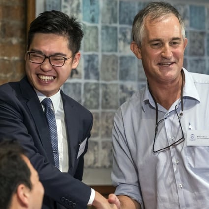 Andy Chan, founder of the Hong Kong National Party, shakes hands with Victor Mallet at the Foreign Correspondents’ Club in Hong Kong where Chan spoke in favour of the city’s independence from Chinese sovereignty, on August 14. Photo: AP