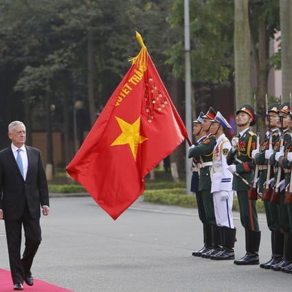 US Defence Secretary James Mattis and his Vietnamese counterpart Ngo Xuan Lich, left, review an honour guard in Hanoi during his first visit. Photo: AP