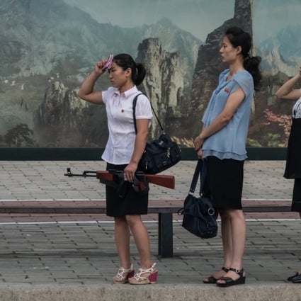 North Korean women wait at a bus stop in Pyongyang. Picture: AFP