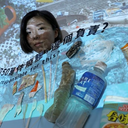 Greenpeace campaigner Chan Hall-sion showing some of the single-use plastic items found in different waterways in Hong Kong. Photo: Sam Tsang