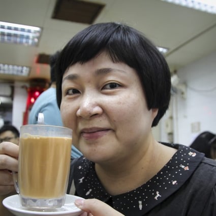 Hong Kong food writer Emily Tong Lai-fong enjoys a Hong Kong-style milk tea at Wai Kee Noodle Cafe in Shan Shui Po, Hong Kong. Photo: Alkira Reinfrank