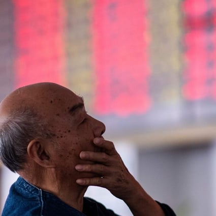 An investor looks at stock information at a brokerage house in Shanghai on October 15. Photo: AFP