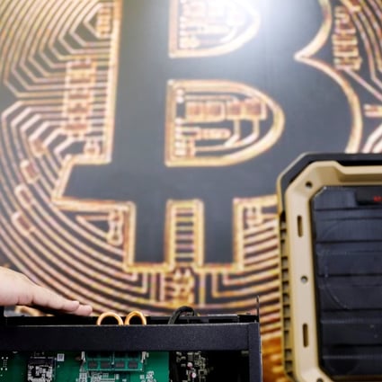 Hong Kong’s outgoing Securities and Futures Commission chairman has said the SFC is looking into regulation for cryptocurrencies to protect investors, and a total ban on such platforms is not realistic due to their international reach. Photo: Reuters