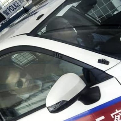 Two police constables were pictured sleeping in a police car while on duty in Kwai Chung on Tuesday morning. Photo: Facebook