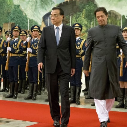 Chinese Premier Li Keqiang and Pakistan's Prime Minister Imran Khan review an honour guard at the Great Hall of the People in Beijing. Photo: AP
