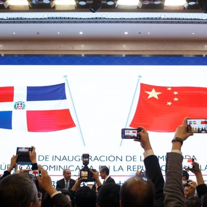 People take pictures during the opening ceremony of the Dominican Republic's embassy in Beijing. Photo: AFP