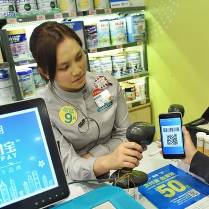 A customer uses Alipay, the online and mobile payment platform operated by Ant Financial, to pay for goods at a pharmacy in Hong Kong. The company is among China’s tech “unicorns”. Photo: Xinhua