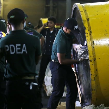 A member of the Philippine Drug Enforcement Agency opens a magnetic lifter containing packs of the drug shabu. Photo: AP