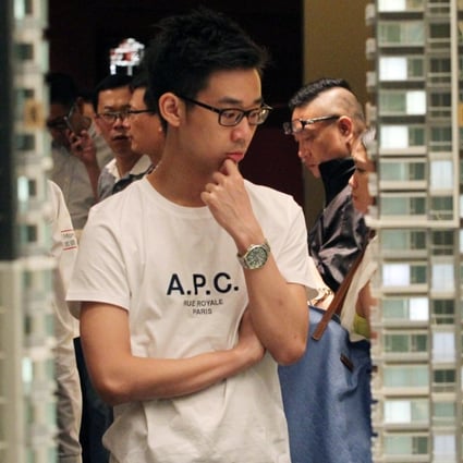 Potential buyers browse a model of Reach Summit, where a batch of 152 flats went on sale on Monday. Photo: Nora Tam