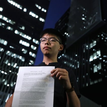 Activist Joshua Wong Chi-fung, secretary-general of pro-democracy party Demosisto, with the party’s report.Photo: Sam Tsang