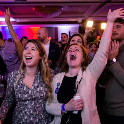 Alyssa Giammarella and Claire Viall cheer as they watch election results come in at a Democratic election night rally in Washington. Photo: Reuters