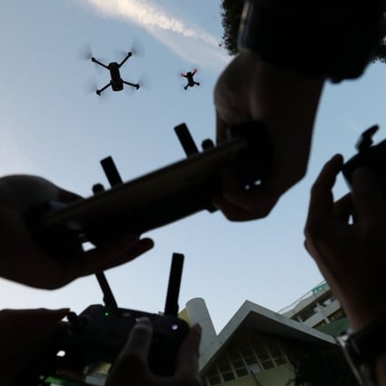 Three DJI drones being flown via remote control over Morrison Hill Road in Causeway Bay, Hong Kong. Photo: Winson Wong