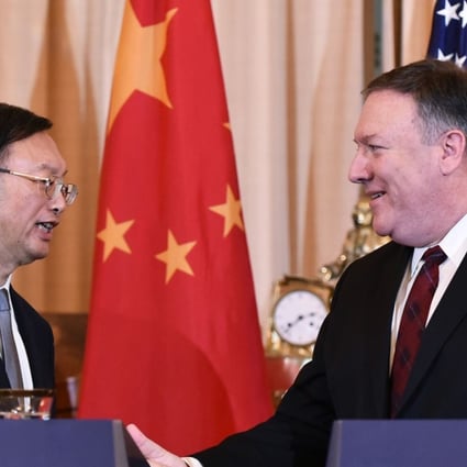 Yang Jiechi and Mike Pompeo shake hands following their press conference in Washington. Photo: AFP