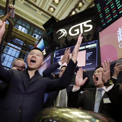 CEO Min Luo (left) and chief financial officer Carl Yeung of online payday loan platform Qudian celebrate as their company’s shares start trading on the New York Stock Exchange on October 18, 2017. The company has since seen its share price tumble amid social media criticism of its high interest rates and regulatory tightening in China. Photo: AP