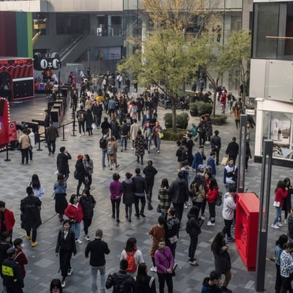 Shoppers walk past stores in Beijing on November 3. Chinese retail sales slowed to 8.6 per cent in October from a year earlier as consumers reined in their spending. Photo: Bloomberg