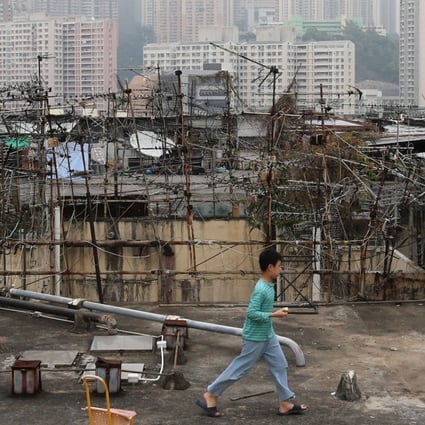 A child outside illegal cubicle homes on the rooftop of an industrial building in Kwun Tong. Photo: Dickson Lee