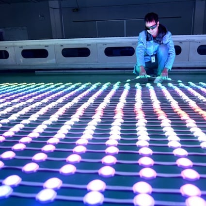 A worker examines LEDs at a manufacturing plant in Haian, Jiangsu province, China. Photo: Reuters