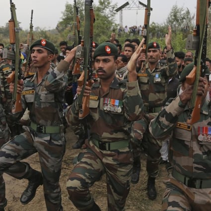 Indian army soldiers pay their respect during the cremation ceremony of a fellow soldier. Photo: AP