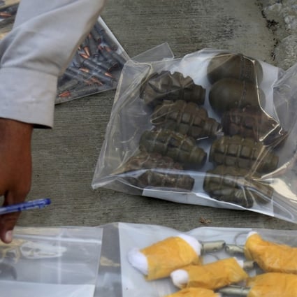 An investigation officer checks ammunition recovered from an attack on the Chinese Consulate in Karachi, Pakistan on November 23, 2018. Photo: AP