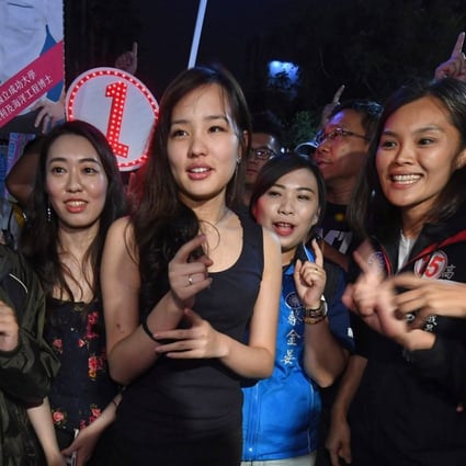 Coco Han (centre) turned her hand and her organisational skills to helping her father, the KMT Kaohsiung mayoral candidate Han Kuo-yu. Their message struck a chord with young and social media-aware voters. Photo: CNA