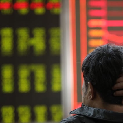 An investor looks on as prices fall at a stock brokerage house in Beijing. Photo: Simon Song