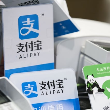 Signs for Alipay and Tencent’s WeChat Pay at a Takeya Co. Ueno Select shop in Tokyo, Japan, on Saturday, December, 2017. Photo: Bloomberg