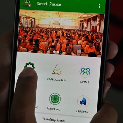 The new government app encourages users to report suspected acts of heresy. Photo: AFP