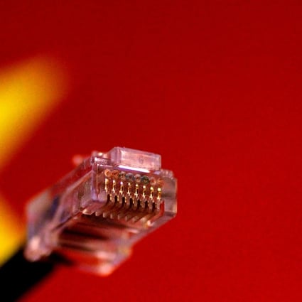 A computer network cable is seen above a Chinese flag. Photo: Reuters
