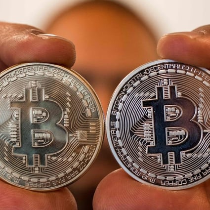A person holding a visual representation of the digital crypto-currency Bitcoin, at the "Bitcoin Change" shop in the Israeli city of Tel Aviv. Photo: AFP