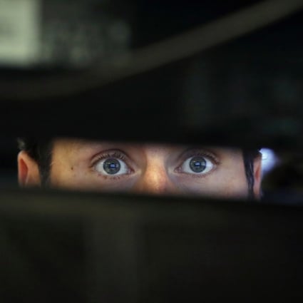 Specialist Michael Pistillo watches the screens at his post on the floor of the New York Stock Exchange on November 28. Photo: AP