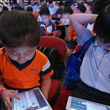Students at the Chinese Chess Challenge "1K VS AI" Battle Day at Queen Elizabeth Stadium in Wan Chai. 1000 students play against Chinese chess artificial intelligence (AI) systems to compete for the championships of the primary and secondary categories and attempt to set a world record for "The Most People Battling Against an Artificial Intelligence Chinese Chess System on the Spot Simultaneously". Photo: David Wong