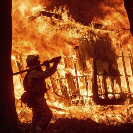 Flames from the Camp Fire consume a home in California on November 9. There is a link between climate change and bigger fires in California. Photo: AP