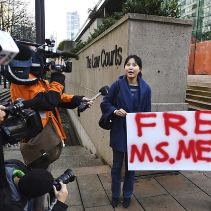 Supporters holding a sign at a Vancouver, British Columbia, courthouse prior to the bail hearing for Sabrina Meng Wanzhou, Huawei's chief financial officer, on Monday. Meng has been detained at the request of the US since December 1. Photo: The Canadian Press via AP)