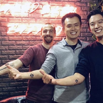 Luke Wagman of CoinMarketCap (left), Binance founder Zhao Changpeng (centre) and blockchain investor Gareth Lai show off their tattoos. Photo: Medium