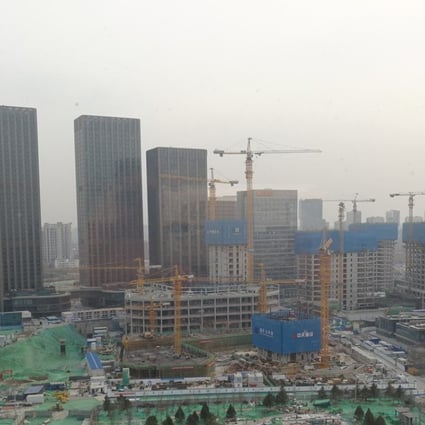 View of construction under way in the Canal Core Area, a planned financial hub on the outskirts of Beijing in Tongzhou district. The finished buildings in the back are residential towers that snuck in before authorities tightened the vetting process for the area. Photo: Zheng Yangpeng