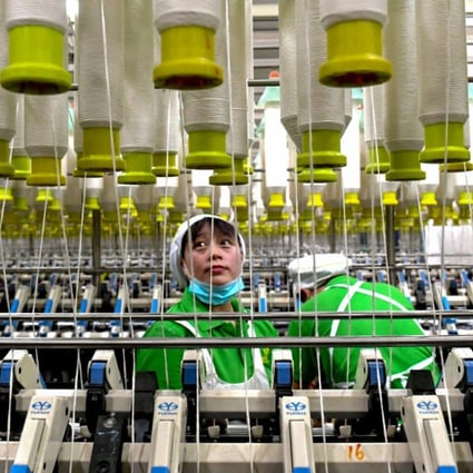 An employee works at a textile factory in Shangqiu in China’s central Henan province. The average nominal minimum wage in China nearly doubled between 2011 and 2018. Photo: STR/AFP